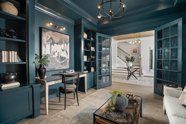 office area featuring french doors, hardwood / wood-style flooring, built in shelves, ornamental molding, and a notable chandelier