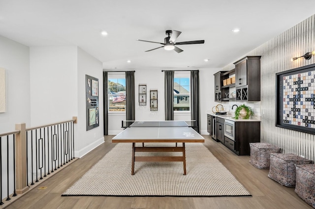 recreation room with light hardwood / wood-style flooring and ceiling fan