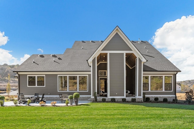 rear view of house with a yard and a patio area