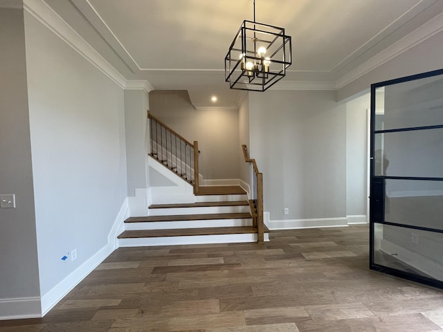 stairway featuring crown molding, a chandelier, and hardwood / wood-style flooring