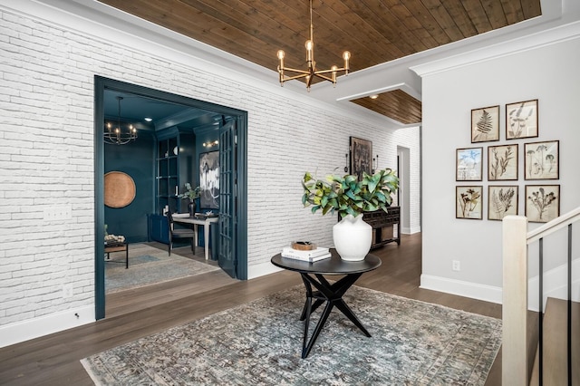 corridor with crown molding, dark hardwood / wood-style floors, wood ceiling, brick wall, and a chandelier