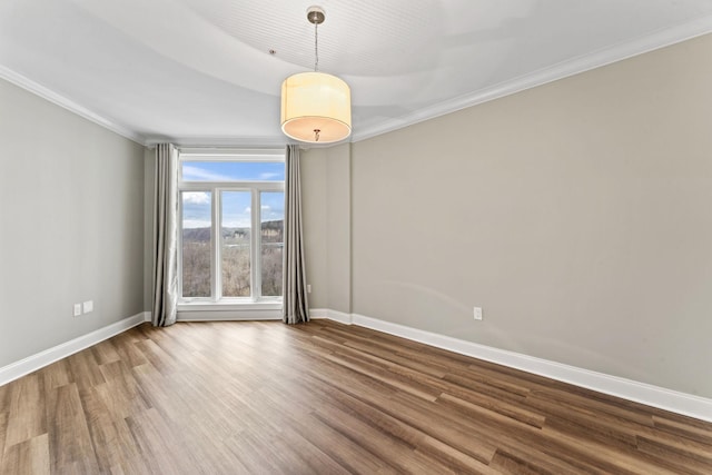 spare room with hardwood / wood-style floors and ornamental molding