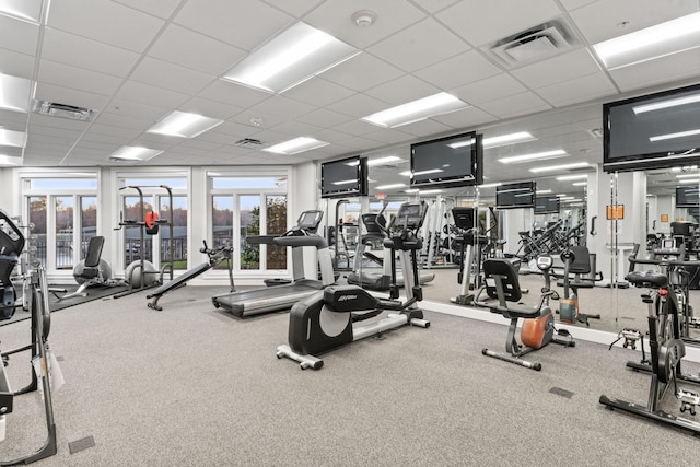 exercise room with a drop ceiling and carpet