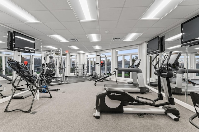 exercise room with a paneled ceiling