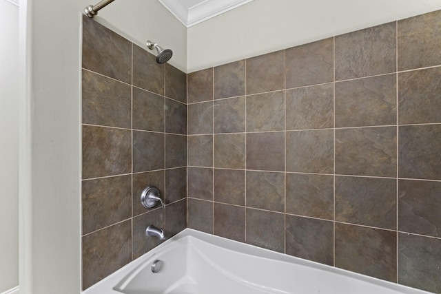 bathroom with tiled shower / bath and ornamental molding