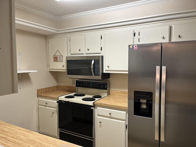 kitchen with white cabinets, stainless steel appliances, and ornamental molding