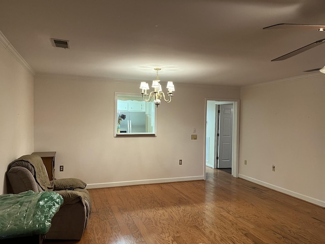 unfurnished room with hardwood / wood-style floors, ceiling fan with notable chandelier, and ornamental molding