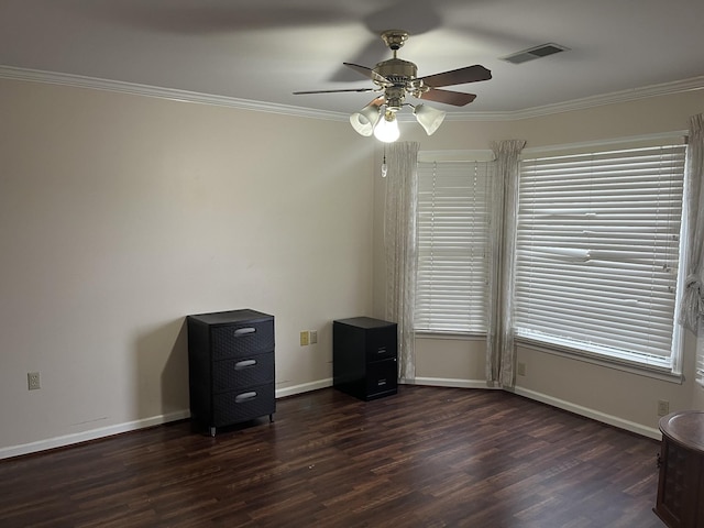 empty room with dark hardwood / wood-style flooring, ceiling fan, and crown molding