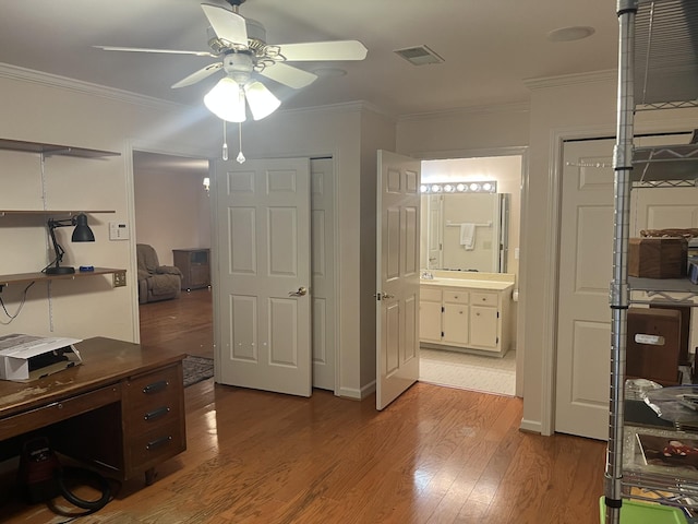 home office featuring ceiling fan, ornamental molding, and light hardwood / wood-style flooring