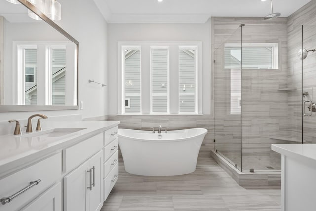 bathroom featuring vanity, a wealth of natural light, tile walls, and plus walk in shower