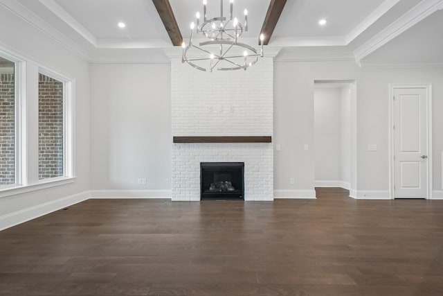 unfurnished living room featuring dark wood-type flooring, beamed ceiling, a chandelier, a fireplace, and ornamental molding