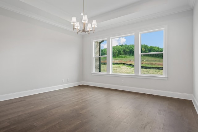 spare room featuring a notable chandelier, dark hardwood / wood-style floors, and crown molding