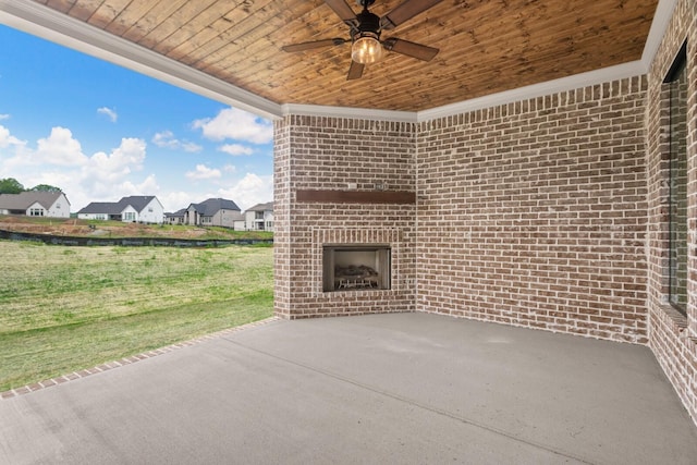 view of patio / terrace featuring ceiling fan and an outdoor brick fireplace