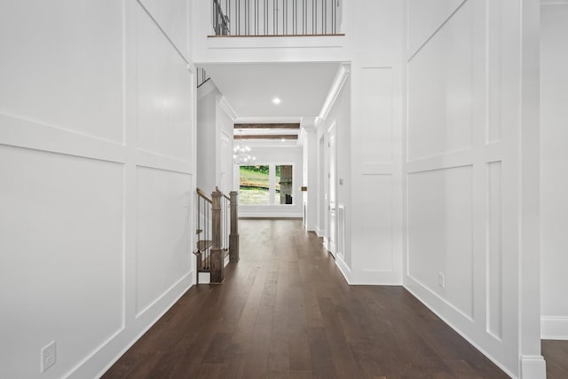 corridor with a chandelier, beamed ceiling, and dark wood-type flooring