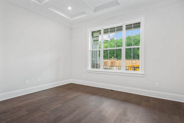 spare room featuring dark hardwood / wood-style floors, beam ceiling, ornamental molding, and coffered ceiling