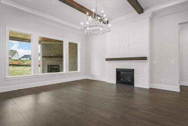 unfurnished living room featuring beamed ceiling, dark hardwood / wood-style flooring, a fireplace, and an inviting chandelier