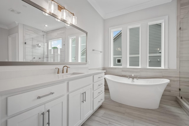 bathroom featuring vanity, separate shower and tub, tile walls, and ornamental molding