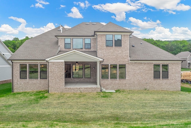 rear view of property featuring a yard and a patio