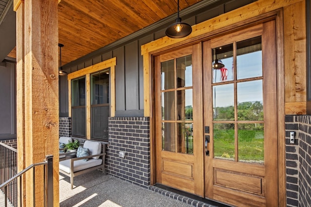 property entrance featuring a porch and french doors