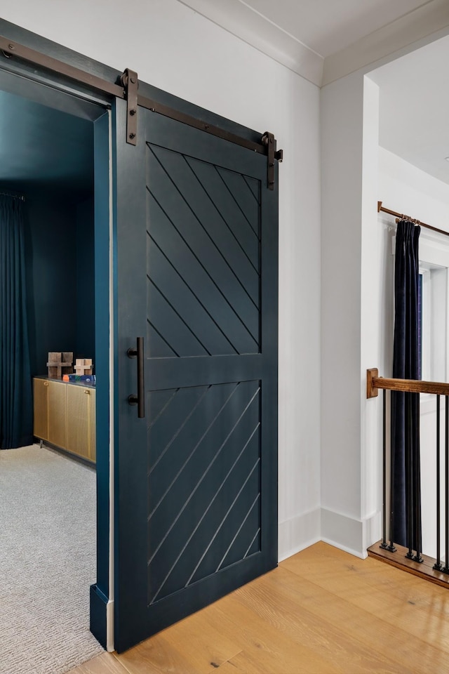 details featuring a barn door and wood-type flooring