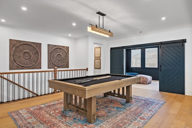 game room featuring ornamental molding, light hardwood / wood-style floors, and billiards