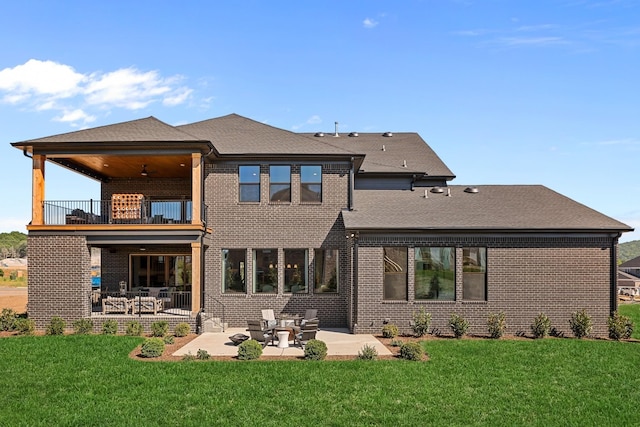 back of house with a yard, a patio area, ceiling fan, and a balcony