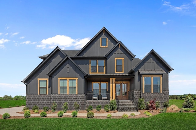 craftsman-style home with a porch and a front lawn