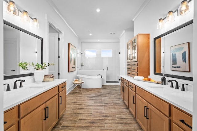 bathroom with vanity, separate shower and tub, and crown molding