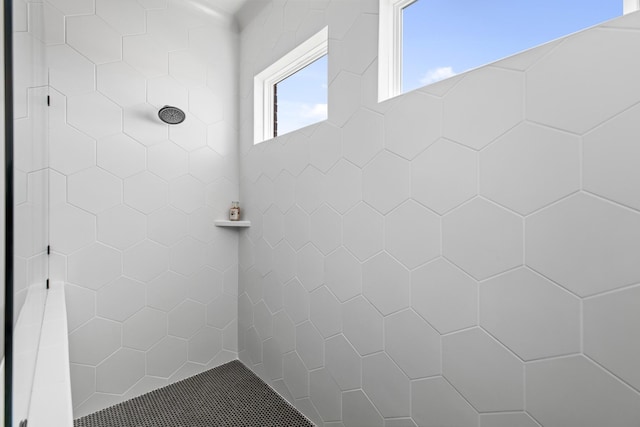 bathroom with tiled shower