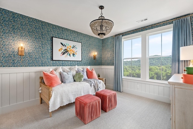 bedroom with carpet floors and a chandelier