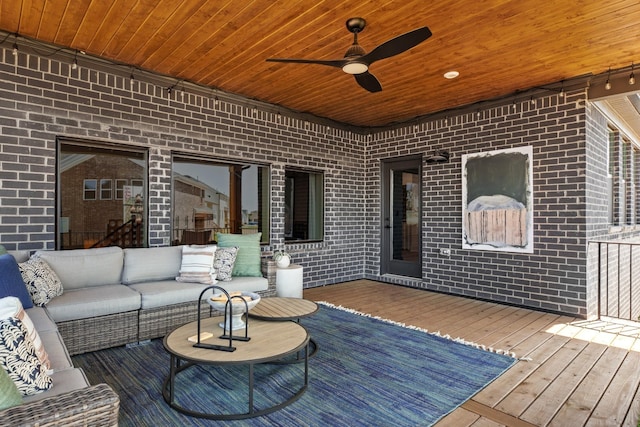 deck with outdoor lounge area and ceiling fan