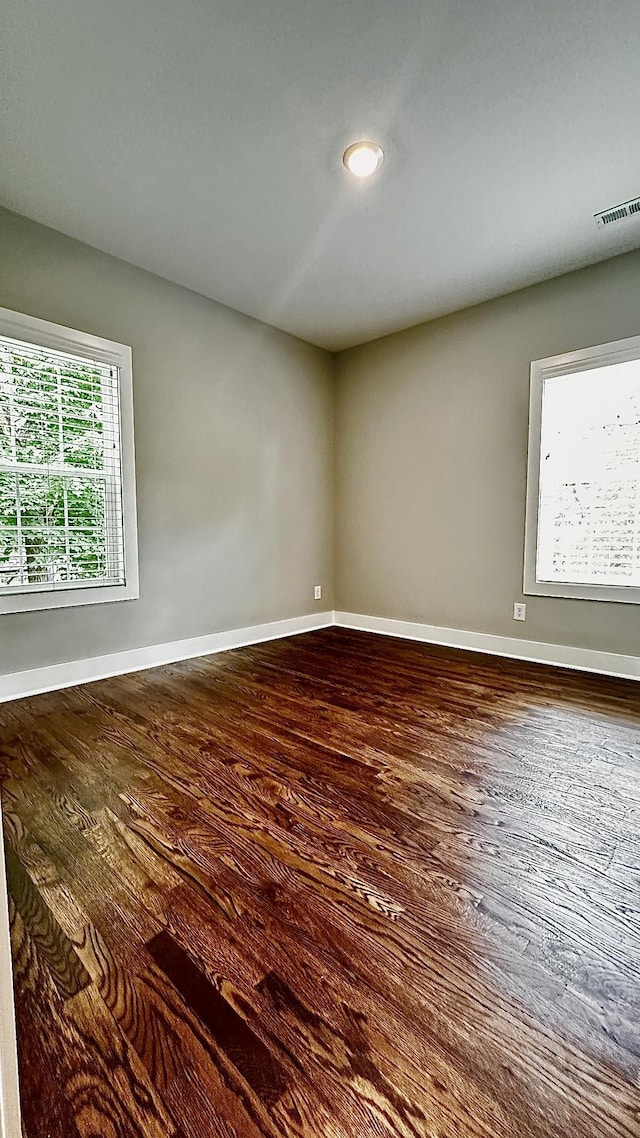 spare room featuring wood-type flooring