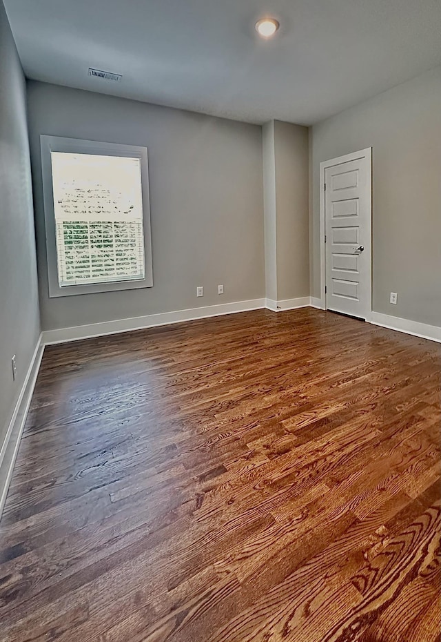 spare room with dark hardwood / wood-style floors