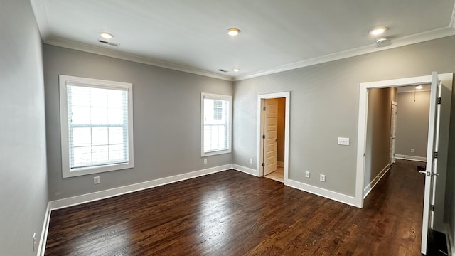 unfurnished bedroom featuring dark hardwood / wood-style flooring, a spacious closet, and crown molding