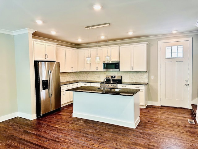 kitchen with a kitchen island with sink, white cabinets, and stainless steel appliances