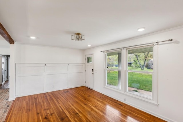 spare room featuring hardwood / wood-style floors and ornamental molding