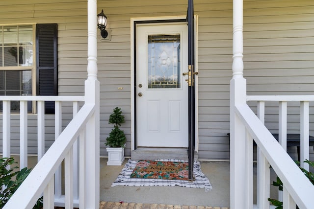 view of exterior entry featuring a porch