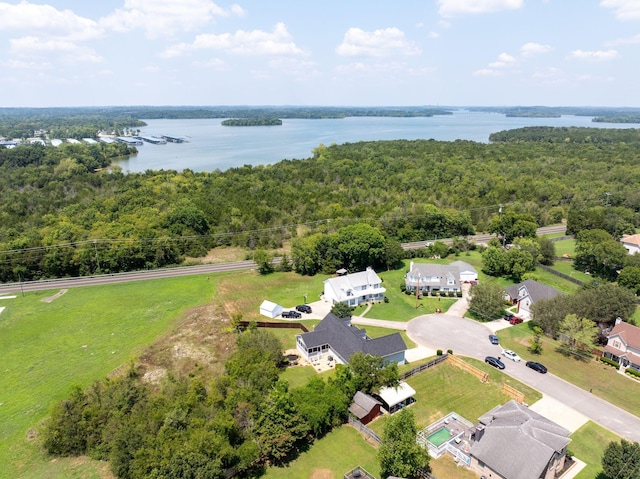 aerial view with a water view and a wooded view