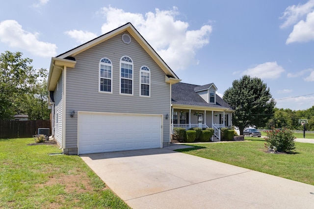 view of front facade featuring covered porch, fence, a front lawn, and concrete driveway