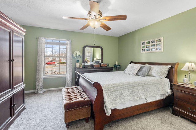 bedroom with light carpet, a ceiling fan, and baseboards