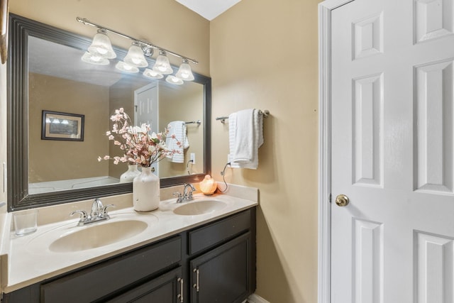 full bathroom featuring a sink and double vanity