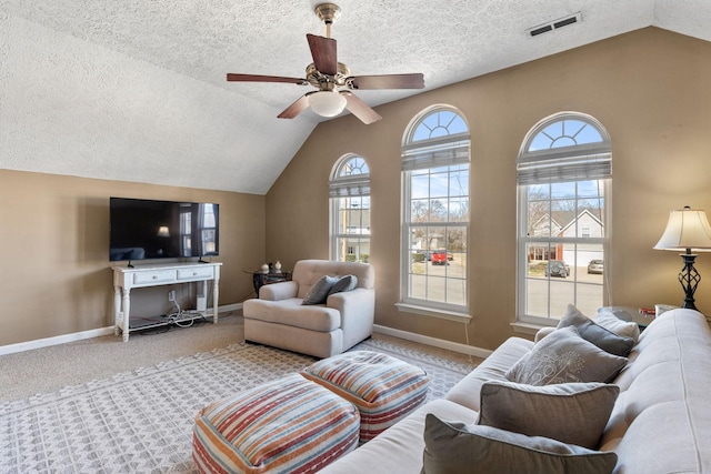 living room with baseboards, visible vents, a ceiling fan, lofted ceiling, and carpet floors