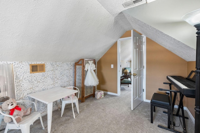 additional living space with light carpet, baseboards, visible vents, vaulted ceiling, and a textured ceiling