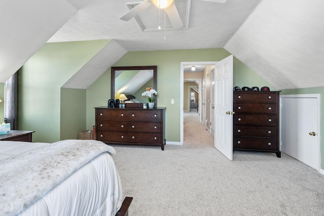 bedroom featuring vaulted ceiling, ceiling fan, carpet flooring, and attic access