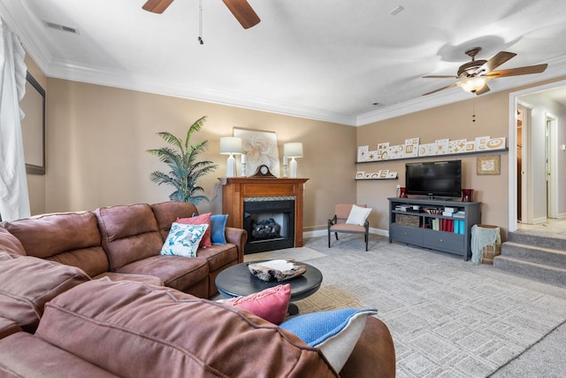 carpeted living area with ornamental molding, visible vents, a fireplace, and baseboards