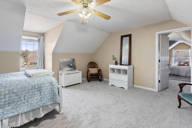 carpeted bedroom featuring vaulted ceiling, a ceiling fan, and baseboards