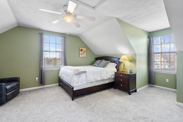 carpeted bedroom with lofted ceiling, baseboards, and a textured ceiling