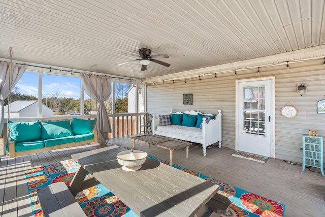 unfurnished sunroom with a ceiling fan