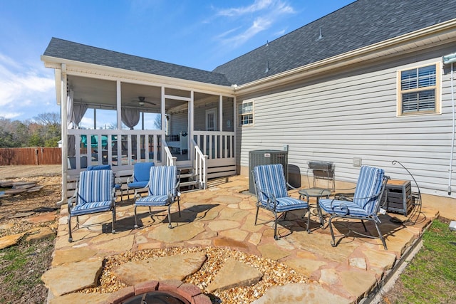 view of patio featuring a sunroom, fence, and central AC unit