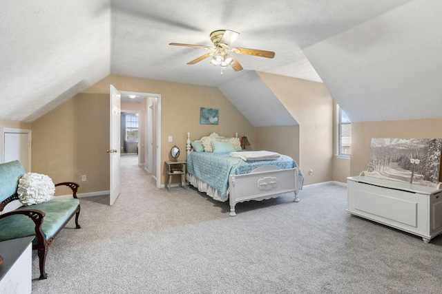 carpeted bedroom with multiple windows, baseboards, and a textured ceiling